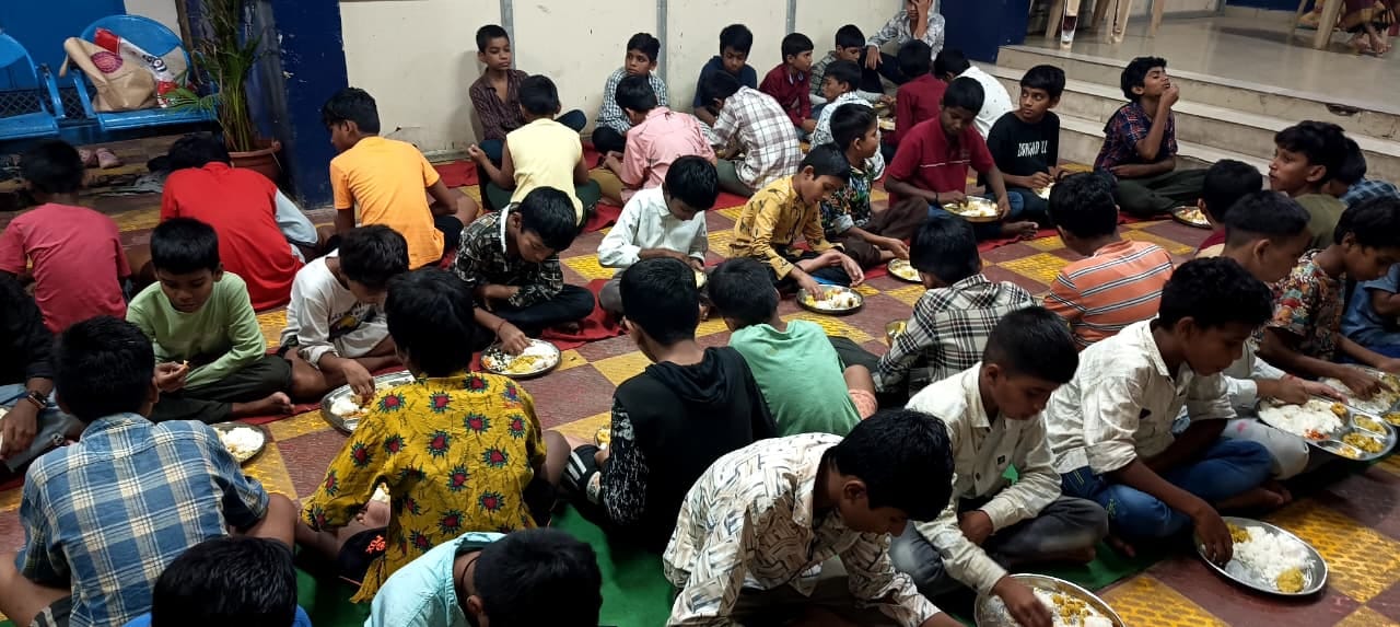 Volunteers and elders sharing a meal seated together