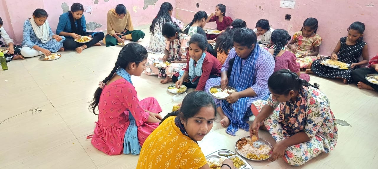 A community group seated for an Annadhanam meal